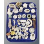 A tray of antique ceramics, dolls tea ware, china figures,