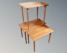 A nest of two mid century Danish teak tables together with a further mid century teak table