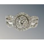 A 9ct white gold diamond set cluster ring, size N.