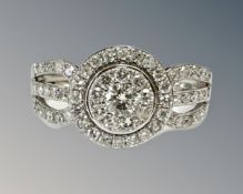 A 9ct white gold diamond set cluster ring, size N.