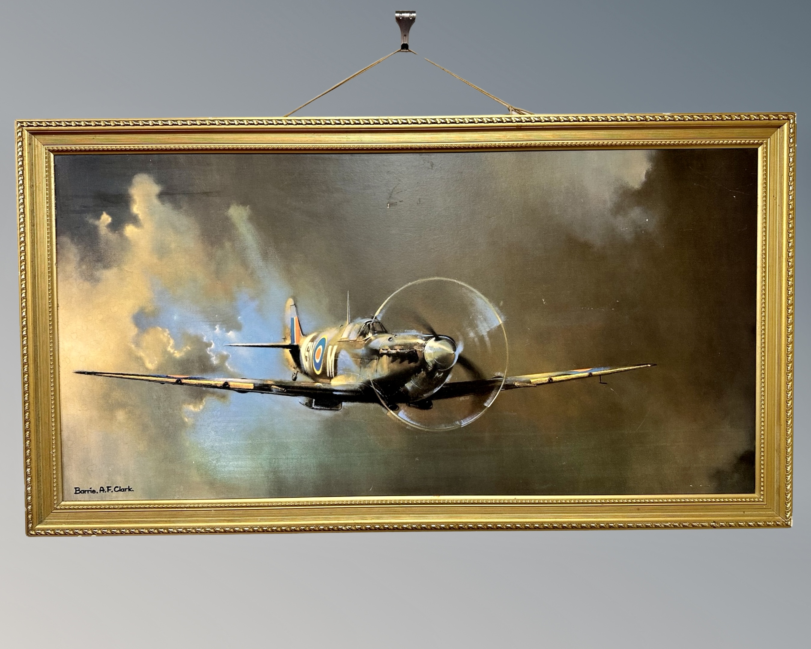 After Barrie Clark : Spitfire coming through clouds, colour print,