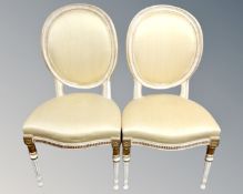A pair of Continental white and gilt dining chairs
