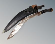 A large kukri knife in sheath,