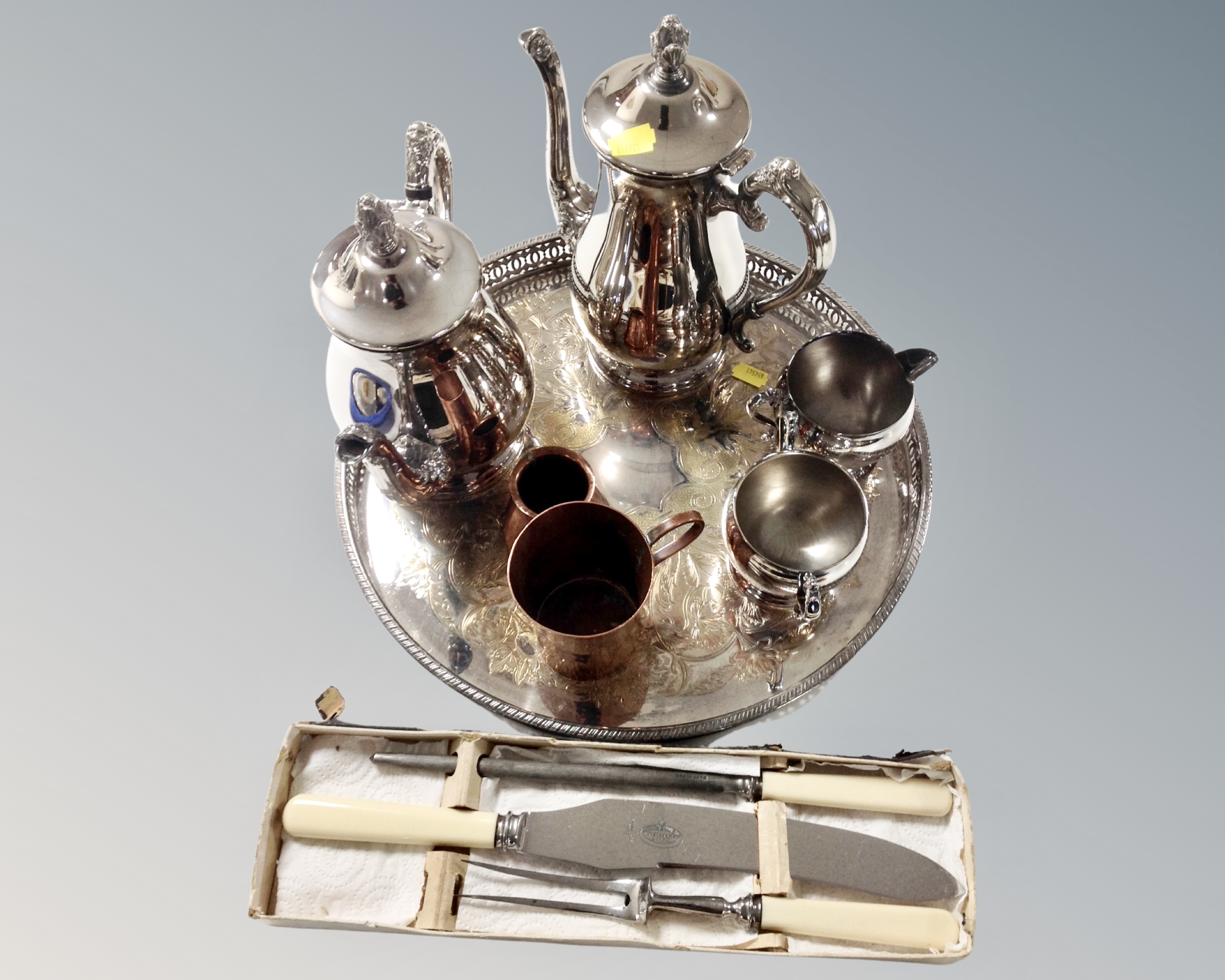 A four piece silver plated tea service on tray together with two pieces of copperware and a