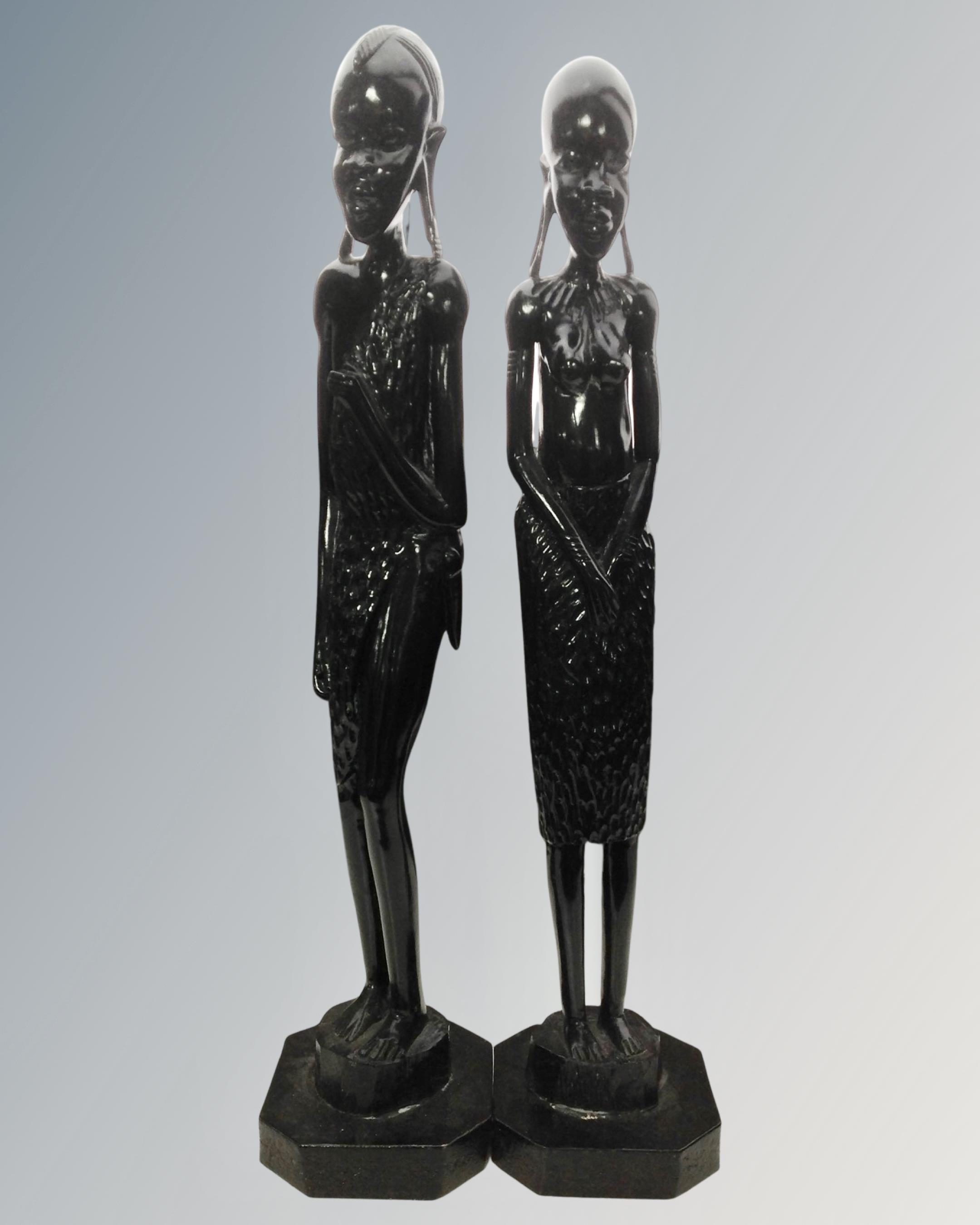 Two large African wooden carved figures on plinths