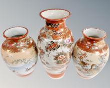 A pair of Japanese satsuma vases together with a further satsuma vase.