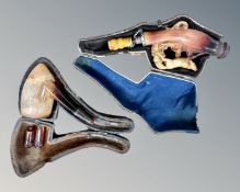 Two Meerschaum pipes in cases.