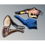 Two Meerschaum pipes in cases.