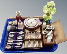 A tray containing a barometer, a glass miniature oil lamp, silver plated cutlery,