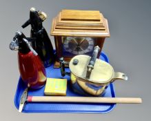 Two vintage soda siphons together with a brass kettle, a brass hammer and an oak cased mantel clock.