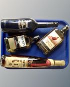 Four bottles of alcohol including Harvey's Bristol Cream, Teacher's Scotch,