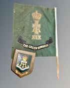 An oak military plaque for the Yorkshire Regiment the Green Howards, with banner on pole.