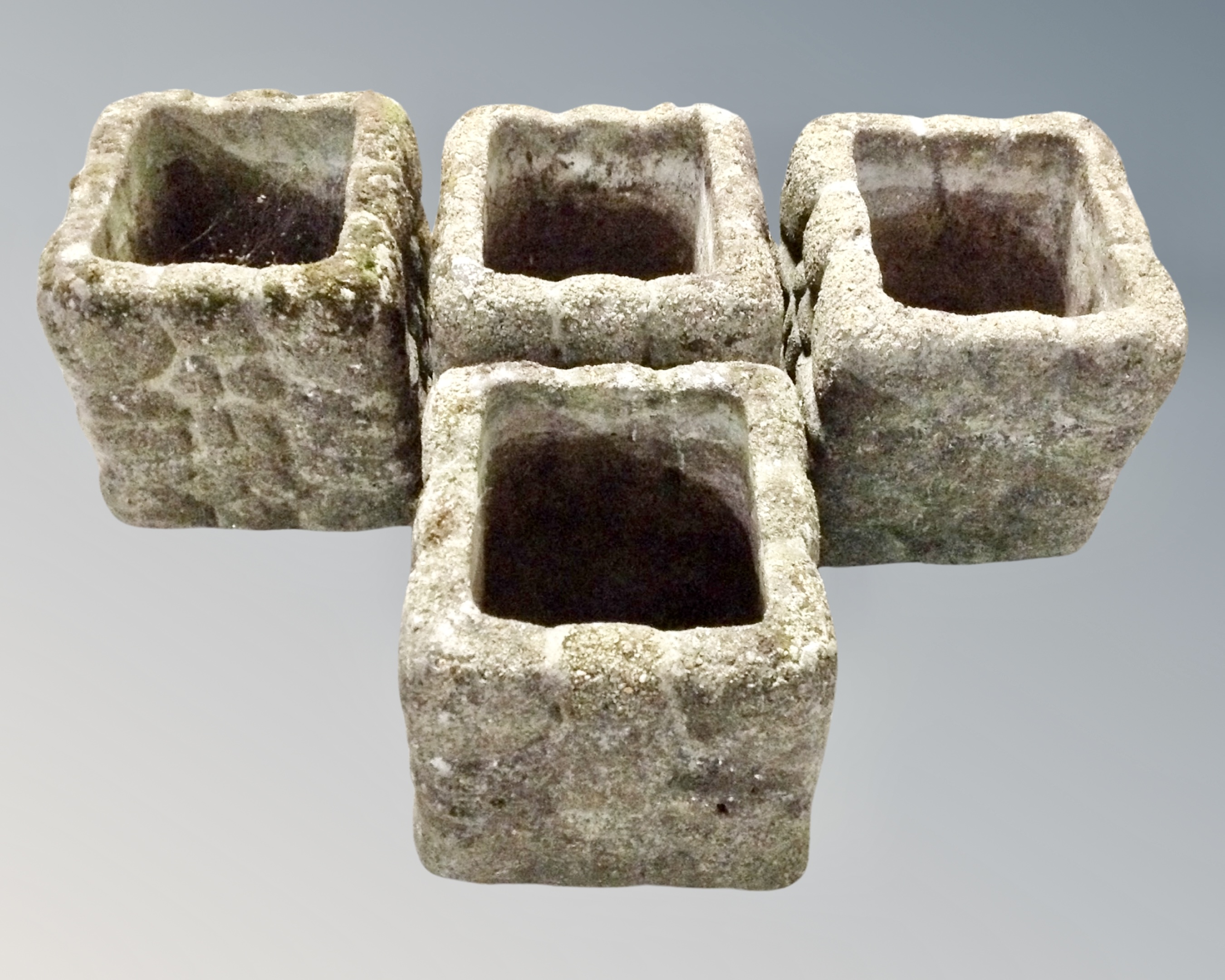 A set of four concrete planters