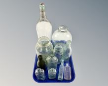 A tray containing vintage glass bottles including Boots the Chemists, Dinneford's Magnesia,