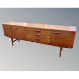 A mid century teak Avalon furniture low sideboard on raised legs