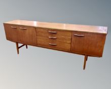 A mid century teak Avalon furniture low sideboard on raised legs
