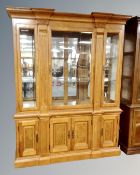 An American Colonial style triple door display cabinet