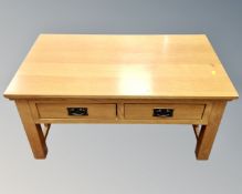 A contemporary oak coffee table fitted with two drawers