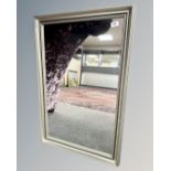 A contemporary mirror in a silvered frame, 57cm by 87cm.