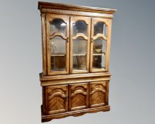 An American Colonial style triple door display cabinet