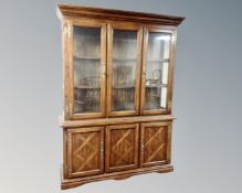 An American Colonial style triple door display cabinet