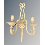 A brass twin branch wall sconce.