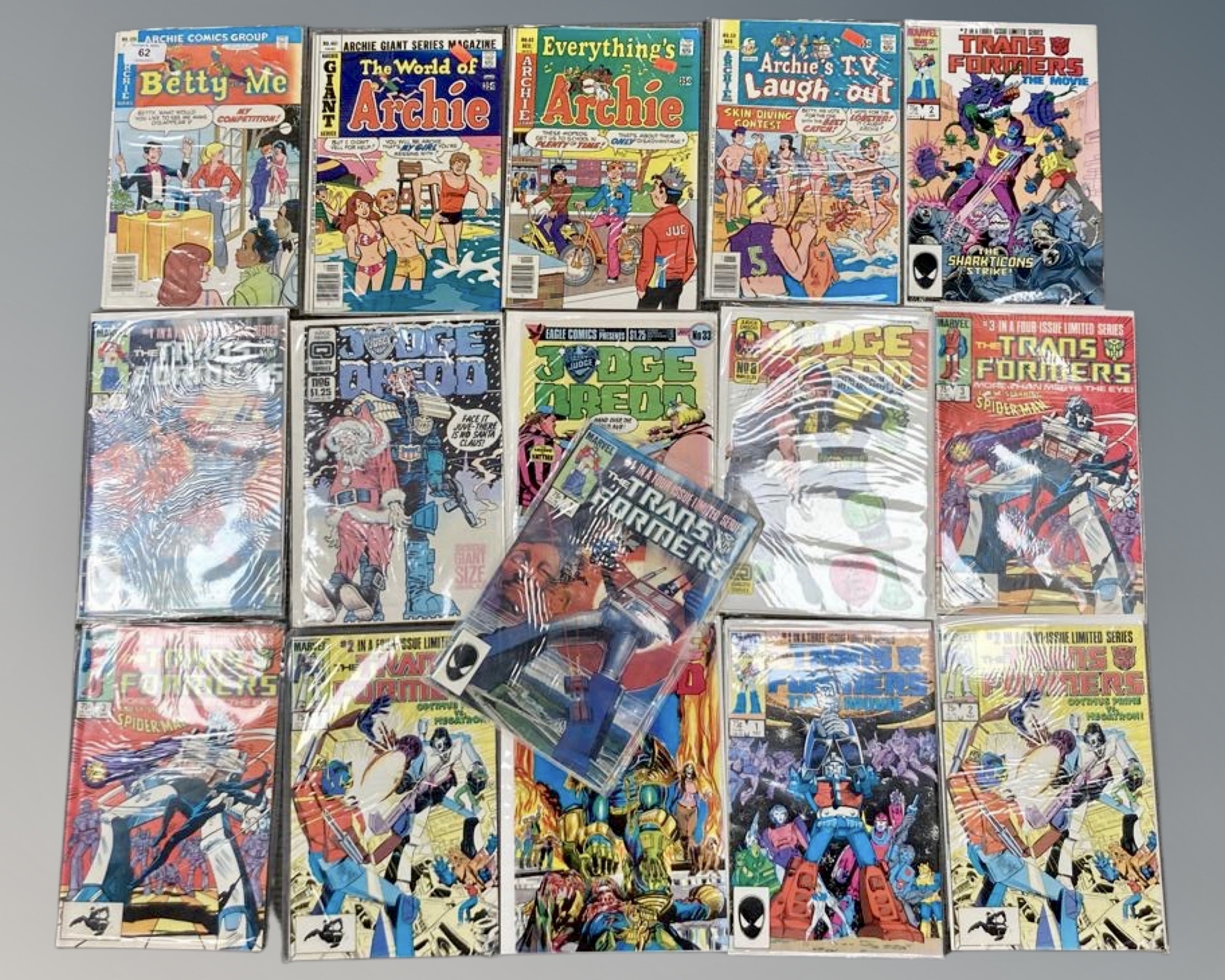 A collection of comics including Archie, Judge Dredd and Marvel's Transformers issues.