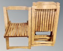 A set of four folding chairs with wooden slatted seats.