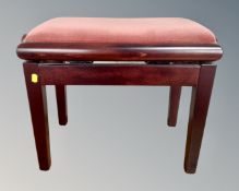 A contemporary adjustable piano stool