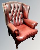 A Chesterfield Burgundy leather wingback armchair