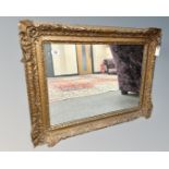 An antique gilt framed mirror, 80cm by 62cm.