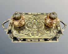 A Victorian cast brass and ceramic desk stand with two inkwells, width 37cm.