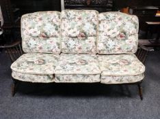 An Ercol stained elm three seater settee (width 173cm)