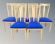 A set of six beech effect spindle back dining chairs