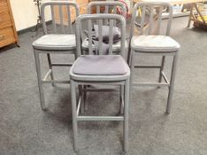 A set of four laminated wooden breakfast bar stools