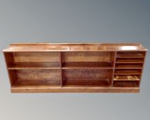 An antique stained pine low open bookshelf