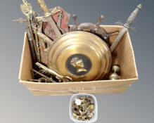 A box of metal ware including brass ornaments, swords, shield, fire pieces,