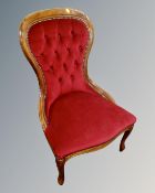 A Victorian style bedroom chair in red buttoned dralon