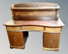 A continental serpentine front mahogany twin pedestal desk (width 140cm)