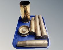 A tray of five brass artillery shells and a trench art ashtray.