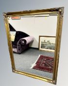 A Victorian style gilded overmantel mirror, 106cm by 137cm.