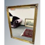 A Victorian style gilded overmantel mirror, 106cm by 137cm.