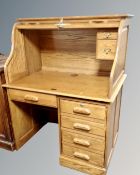 A contemporary oak roll topped single pedestal desk with keys