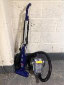 A Bush cylinder vacuum together with a Bissell feather weight stick vacuum