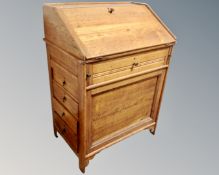 An Edwardian oak writing bureau