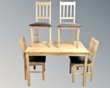 A contemporary kitchen table together with four rail backed chairs