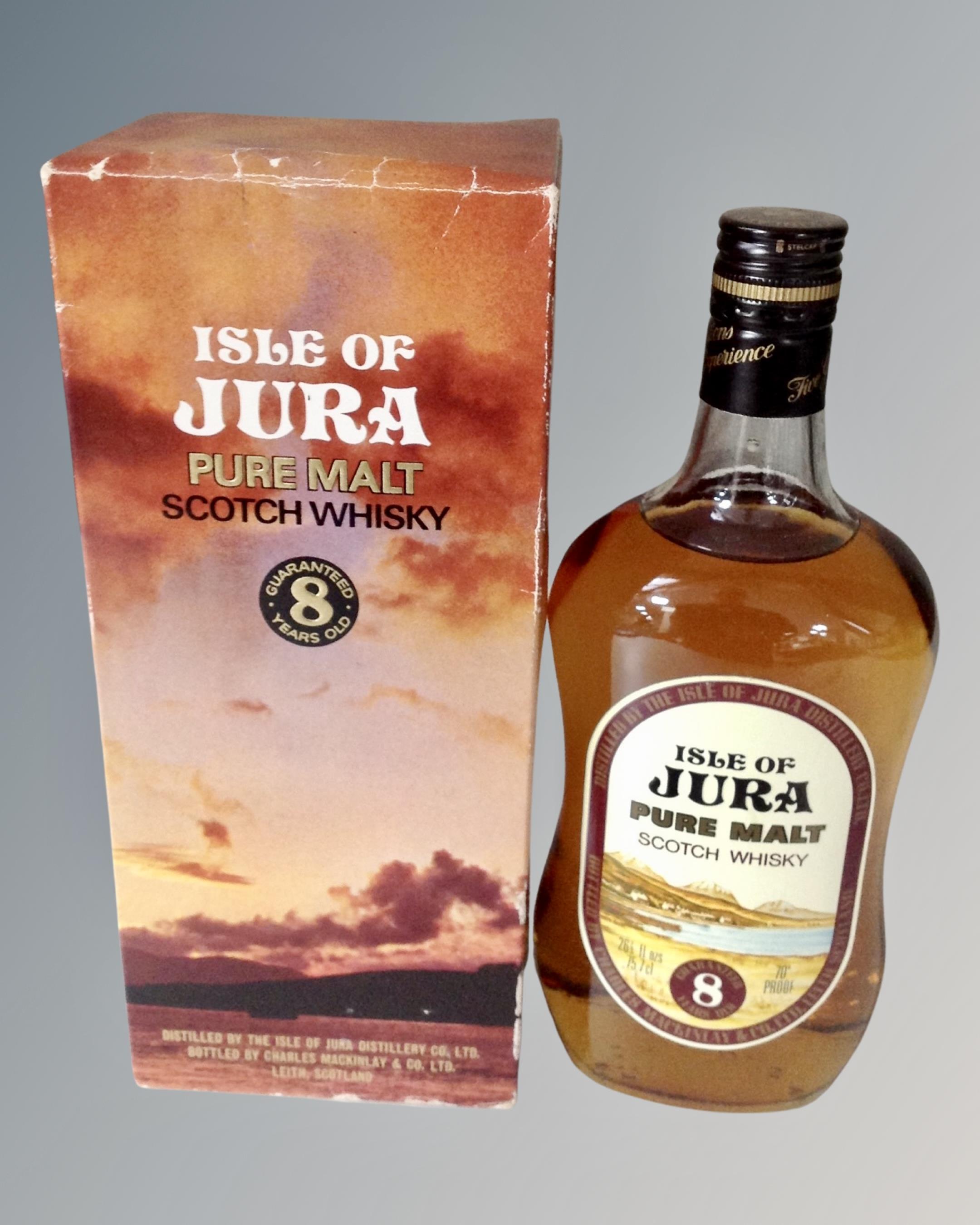 A bottle of Isle of Jura pure malt scotch whisky, eight years old, in box.