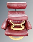 A Stressless Burgundy leather adjustable armchair with matching footstool