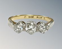 An 18ct gold and platinum three-stone diamond ring, the total diamond weight estimated at 0.