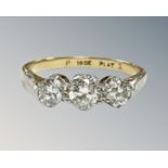 An 18ct gold and platinum three-stone diamond ring, the total diamond weight estimated at 0.